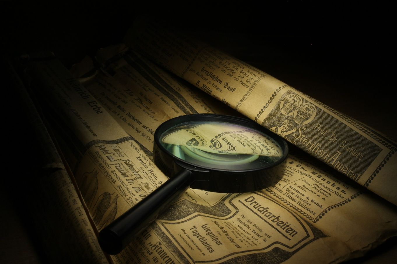 Magnifying glass on old newspaper