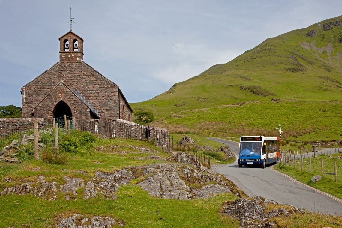 Honister Rambler bus passing Buttermere church