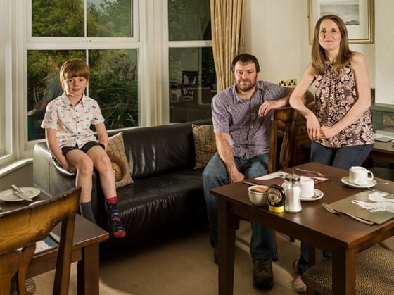 Fern Howe guest house owners with their son in the breakfast room