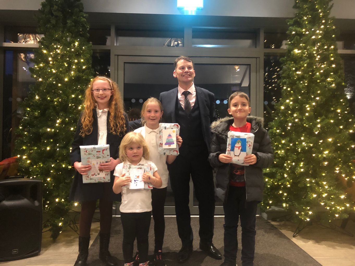 Christmas card competition winners alongside Marcell Cilliers, General Manager of the Lodore Falls Hotel & Spa