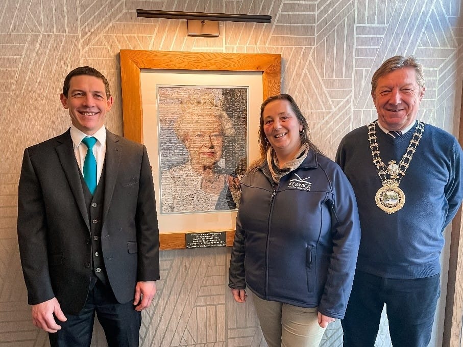 } Neels Ferriera, General Manager of the Skiddaw Hotel; Vanessa Metcalfe, Tourism Manager at Keswick Tourism Association and Alan Dunn, Keswick Mayor photographed with the Queen’s portrait