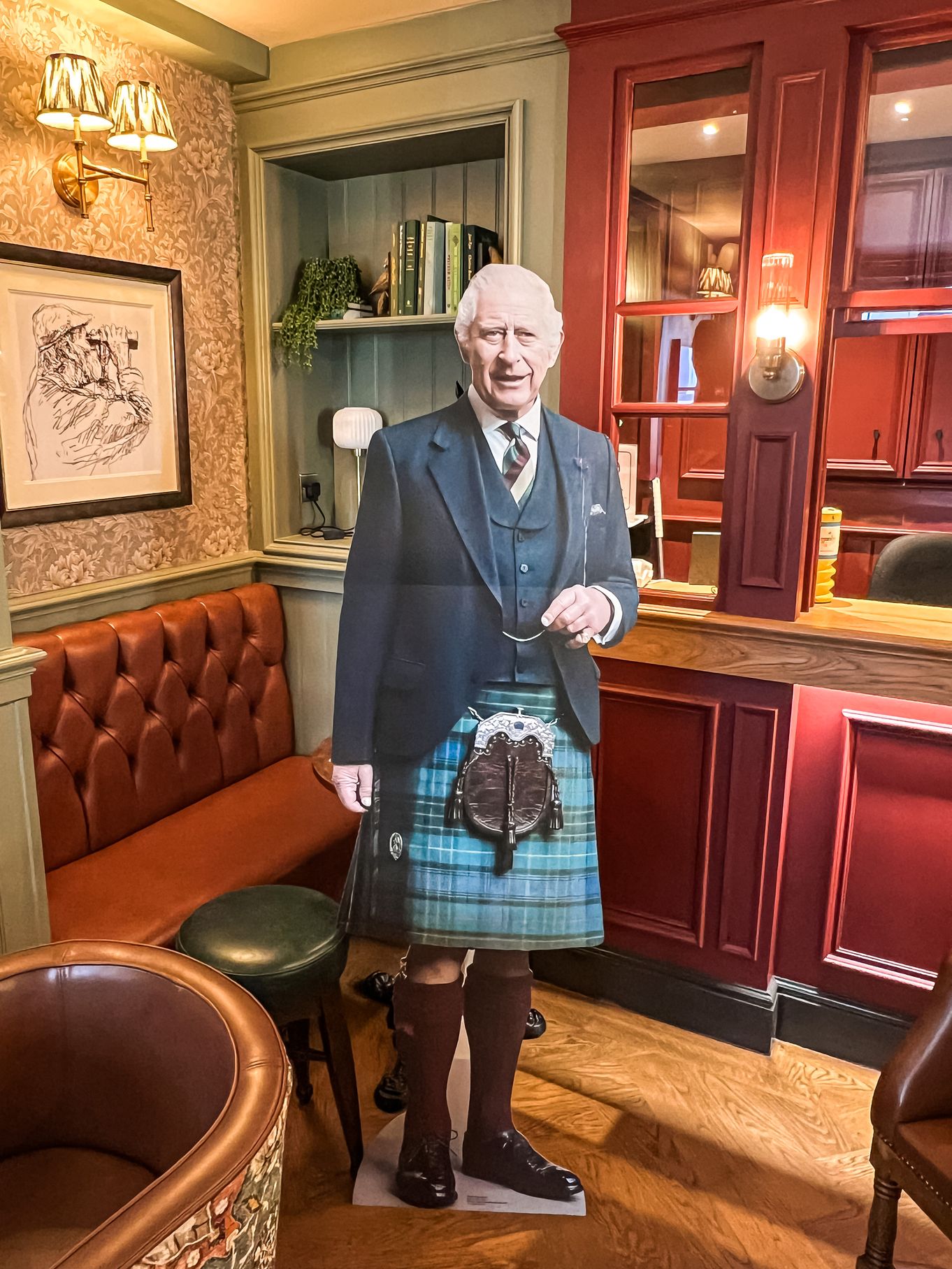 cut out of King Charles wearing a kilt in the bar of the Kings Arms Hotel